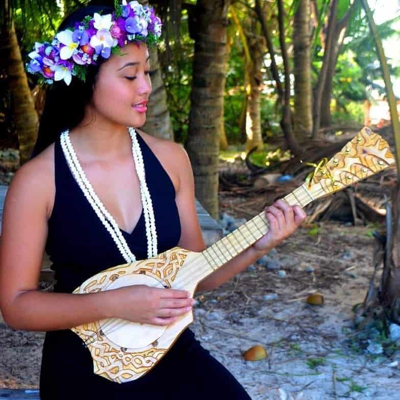 girl playing a cook islands ukulele